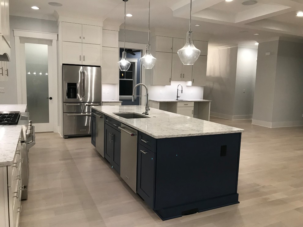 Example of a mid-sized transitional l-shaped light wood floor and beige floor open concept kitchen design in Cincinnati with an undermount sink, shaker cabinets, white cabinets, granite countertops, stainless steel appliances, an island and gray countertops
