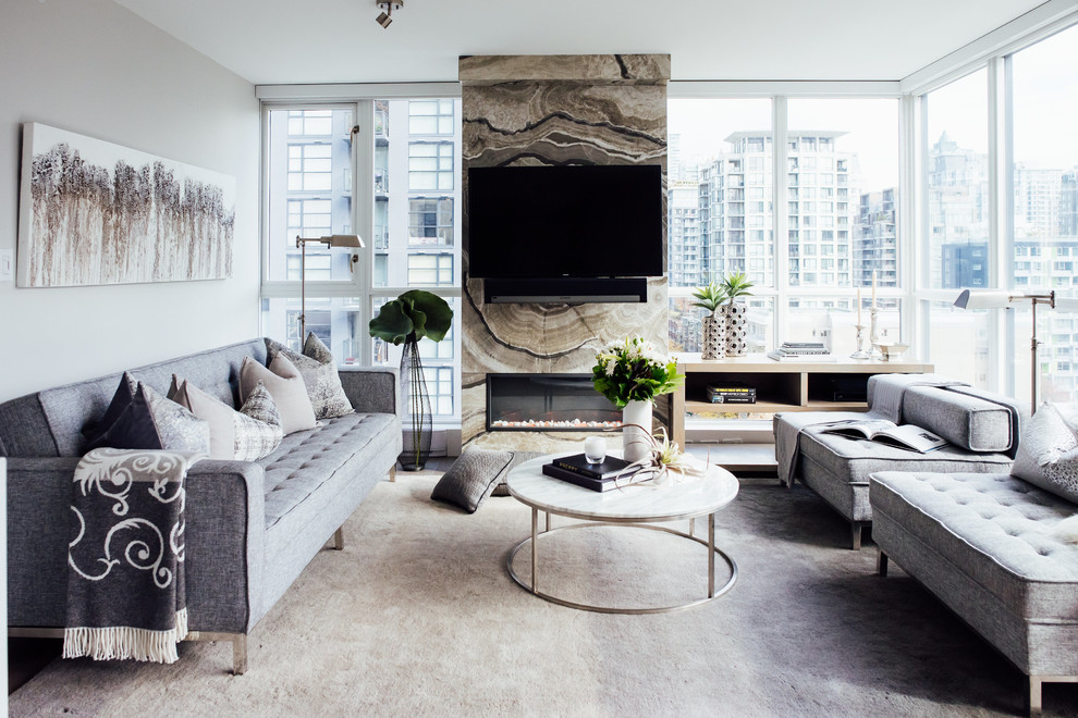 Design ideas for a contemporary family room in Vancouver with beige walls, a ribbon fireplace, a stone fireplace surround and a wall-mounted tv.