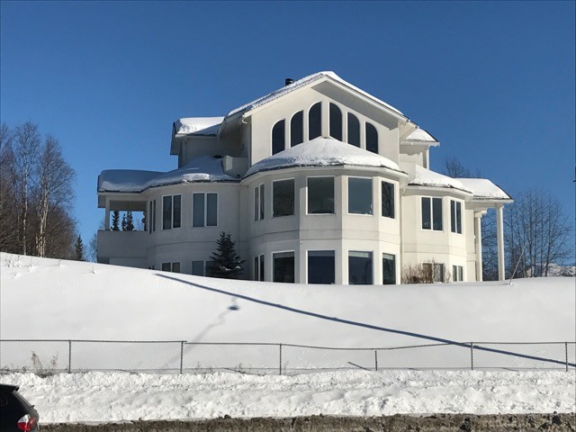 Inspiration for a large transitional white three-story concrete gable roof remodel