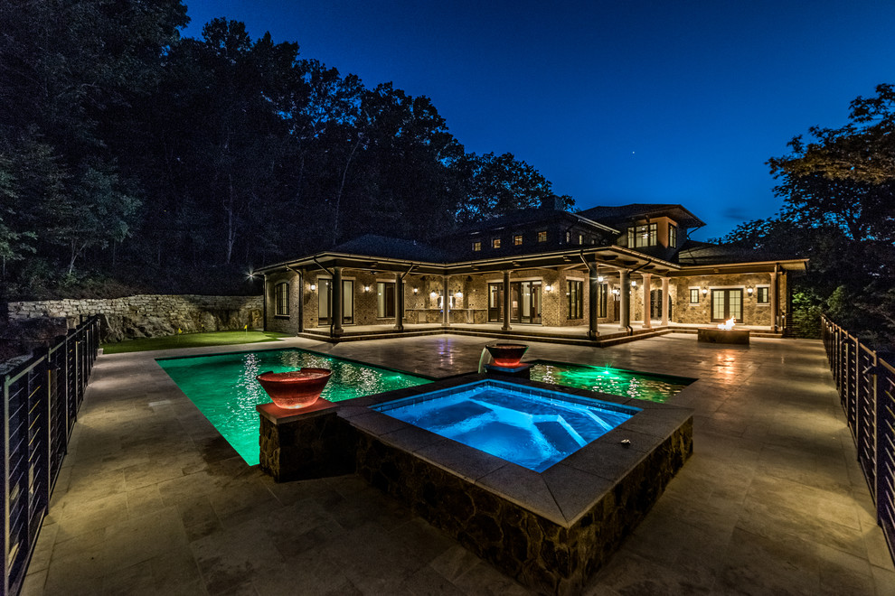 Example of a large mountain style backyard tile and custom-shaped lap hot tub design