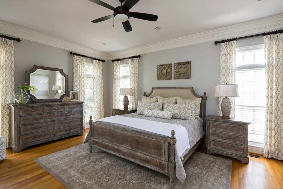 Design ideas for a large traditional master bedroom in Charlotte with grey walls, no fireplace and medium hardwood floors.