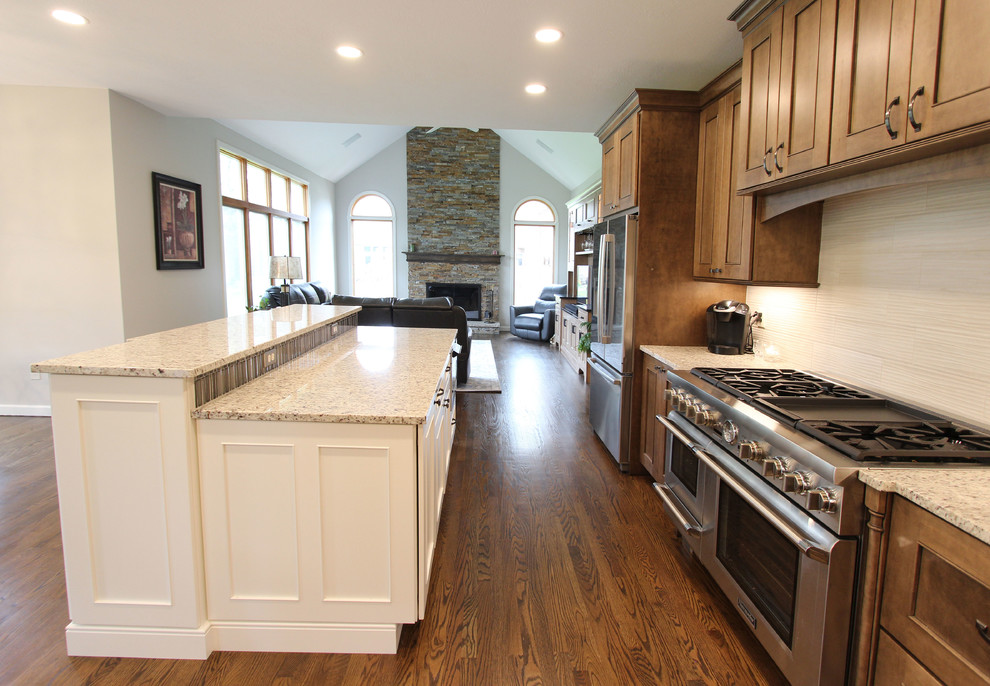 Two Toned Kitchen with White Island and Great Room Stacked Stone Fireplace Transitional