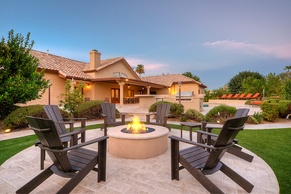 Contemporary patio in Phoenix with a fire feature.