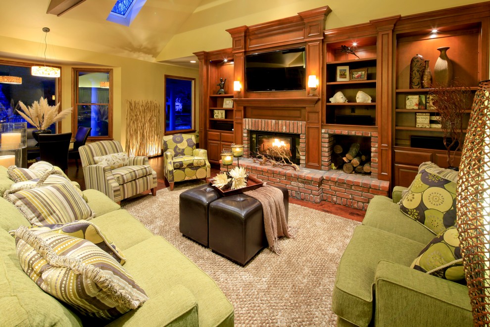 This is an example of a traditional family room in Sacramento with beige walls, a standard fireplace, a brick fireplace surround and a wall-mounted tv.