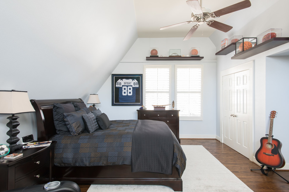 Photo of a large transitional guest bedroom in Dallas with white walls, medium hardwood floors and brown floor.