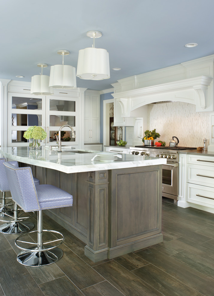 Large transitional u-shaped ceramic tile open concept kitchen photo in New York with an undermount sink, white cabinets, marble countertops, white backsplash, porcelain backsplash, paneled appliances and an island