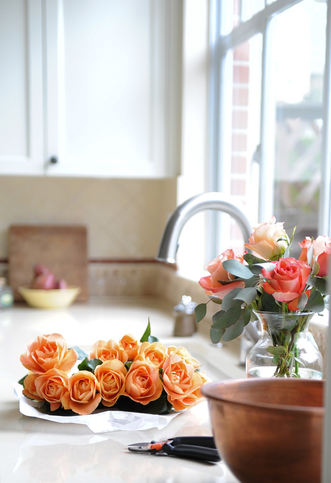 Home design - mid-sized transitional u-shaped dark wood floor home design idea in Vancouver with an undermount sink, recessed-panel cabinets, white cabinets, wood countertops, beige backsplash, terra-cotta backsplash, stainless steel appliances and an island