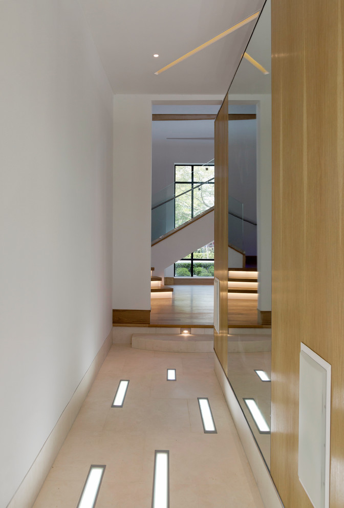 This is an example of a mid-sized contemporary hallway in Houston with white walls, porcelain floors and multi-coloured floor.
