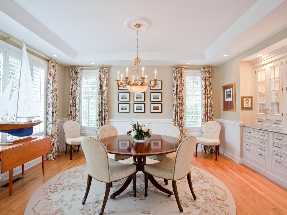 Design ideas for a mid-sized traditional separate dining room in Charleston with beige walls and medium hardwood floors.