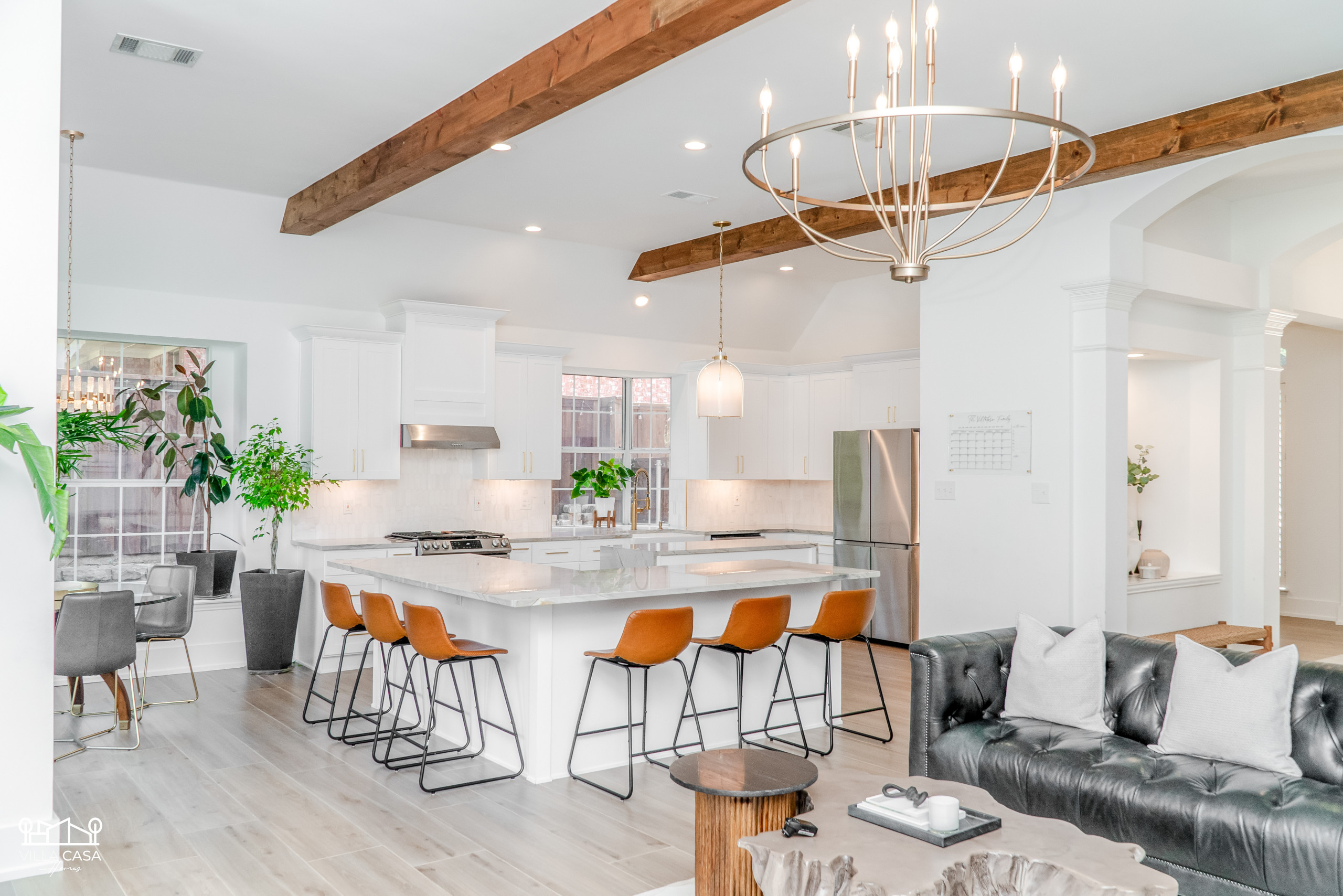 Great open concept living/kitchen/dining - full remodel including beams, lighting fixtures, full kitchen, wall texture, paint, trim, and flooring.