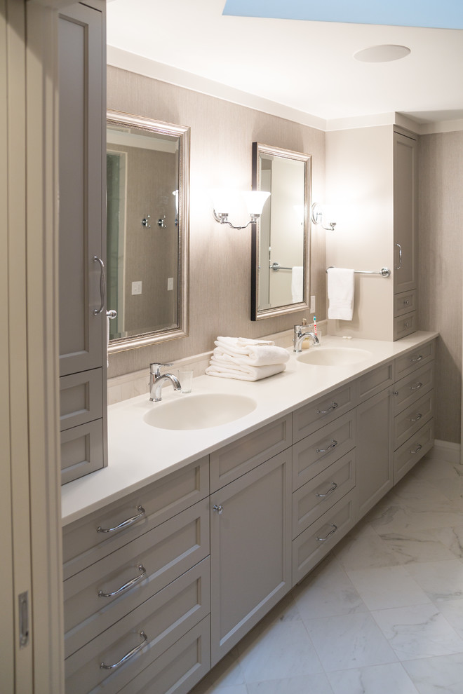 Inspiration for a mid-sized contemporary master bathroom in Minneapolis with grey cabinets, an alcove shower, a one-piece toilet, white tile, stone tile, grey walls, marble floors, an integrated sink, solid surface benchtops and recessed-panel cabinets.