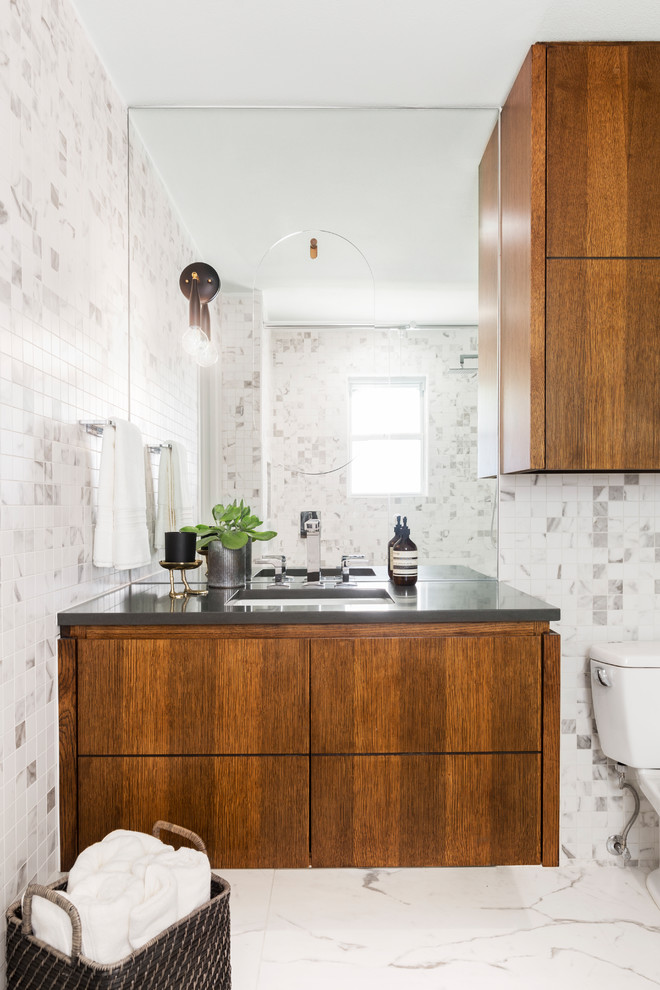 Small contemporary bathroom in Dallas with flat-panel cabinets, dark wood cabinets, an undermount sink, engineered quartz benchtops, white floor, grey benchtops, multi-coloured tile and multi-coloured walls.