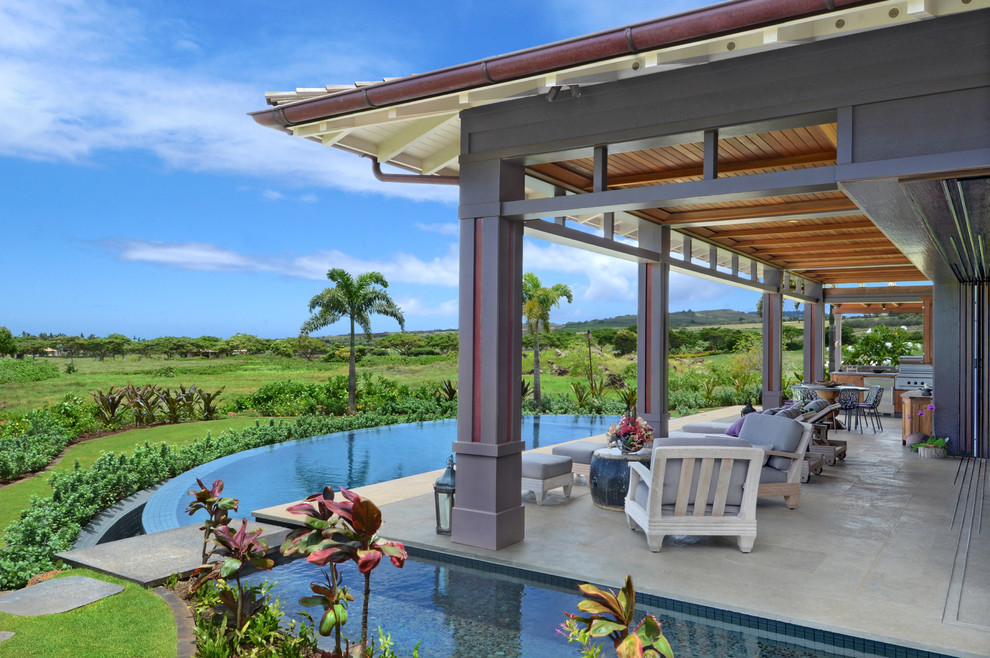 Tropical backyard custom-shaped infinity pool in Hawaii.