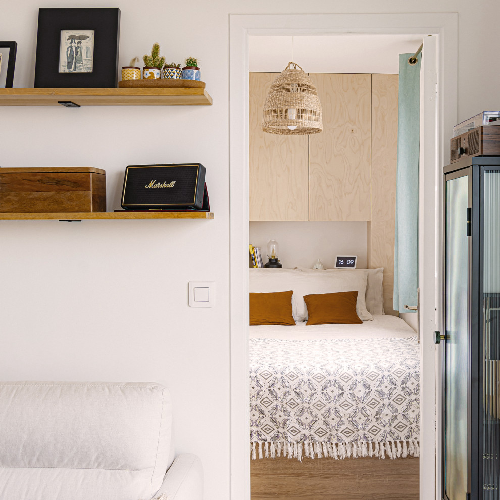 Aménagement d'une petite chambre scandinave avec un mur blanc et parquet clair.