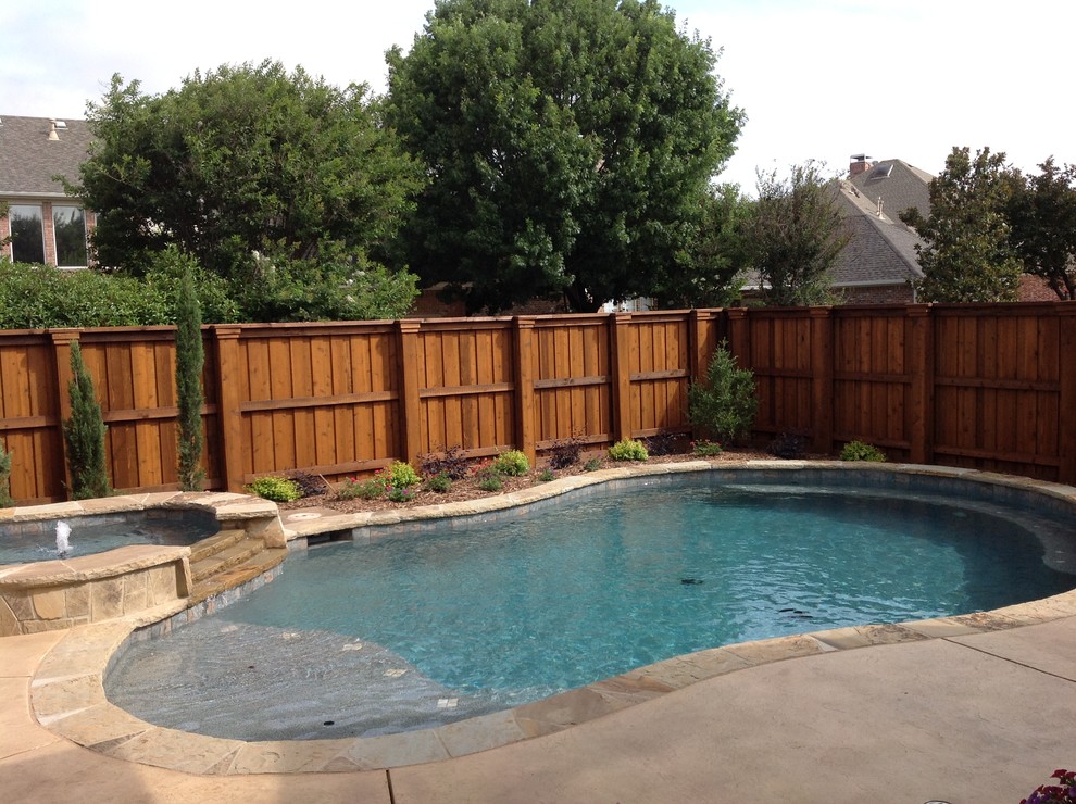 Inspiration for a large transitional backyard custom-shaped hot tub remodel in Dallas
