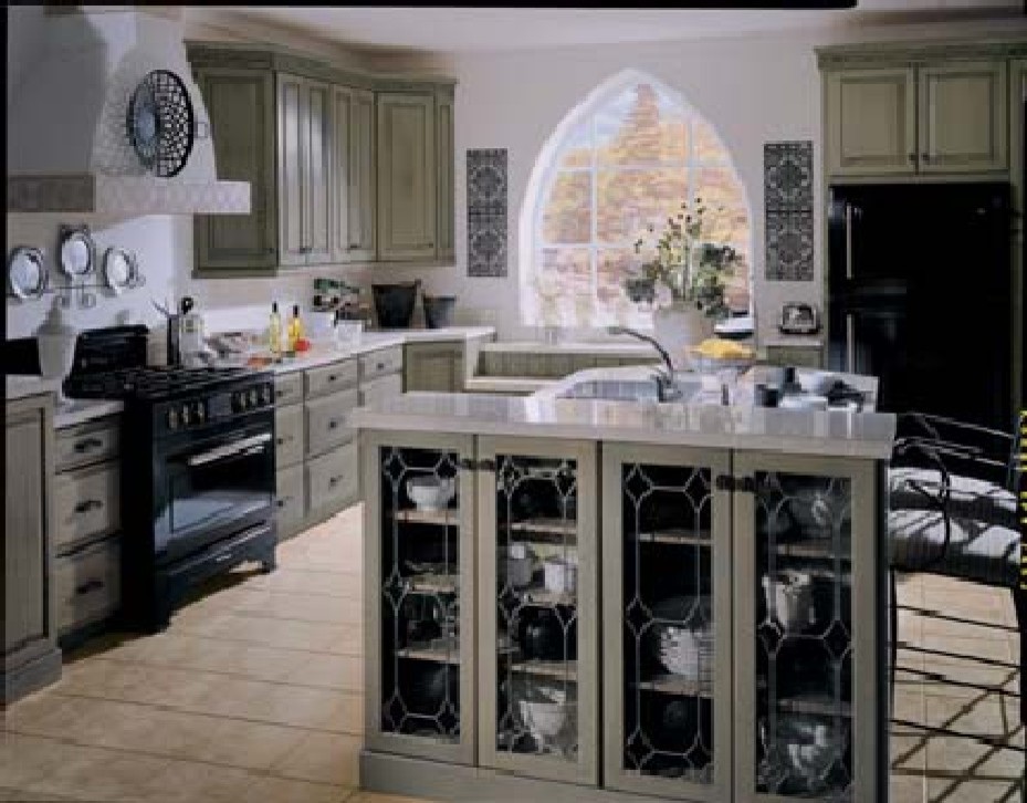 This is an example of a large u-shaped open plan kitchen in Jacksonville with a double-bowl sink, green cabinets, cement tile splashback, black appliances, ceramic floors and with island.