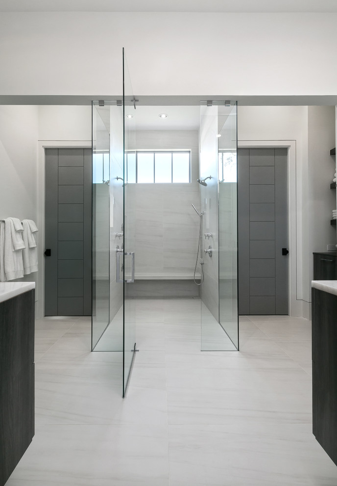 Photo of a large modern master bathroom in Charleston with flat-panel cabinets, grey cabinets, an open shower, a one-piece toilet, white tile, porcelain tile, multi-coloured walls, porcelain floors, an undermount sink, marble benchtops, multi-coloured floor and a hinged shower door.