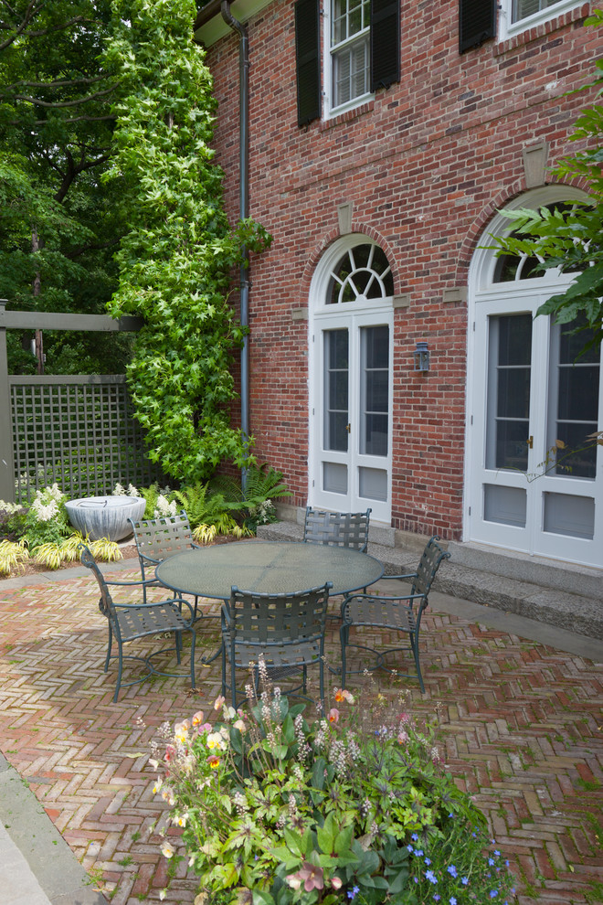 This is an example of a traditional patio in Boston with brick pavers.