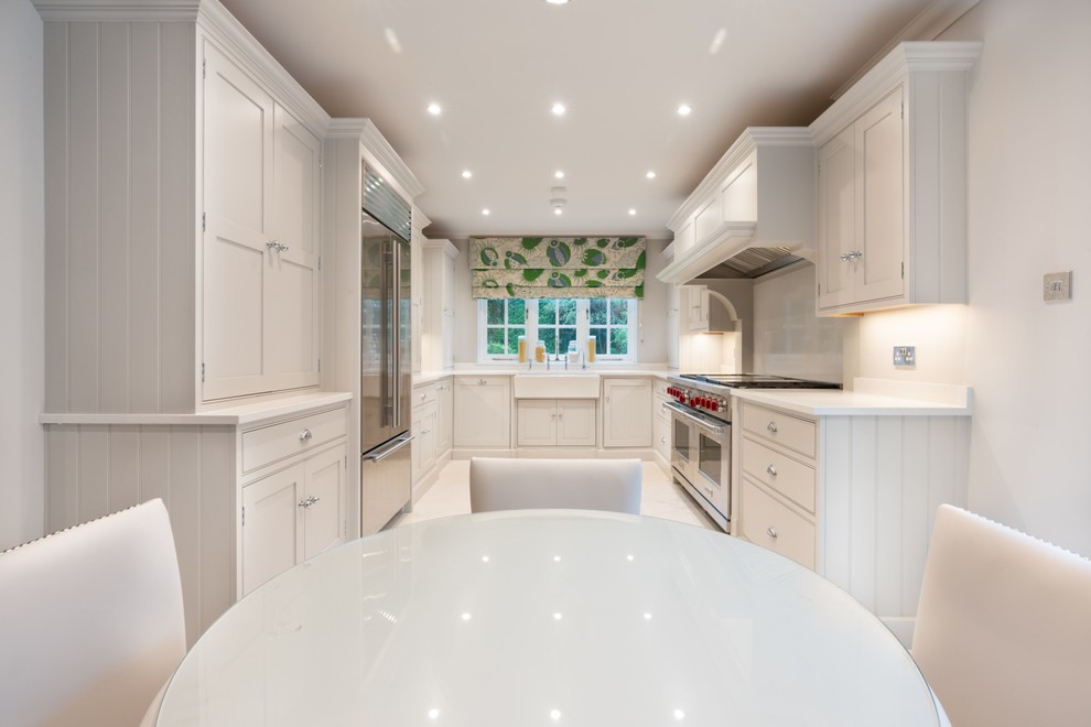 Inspiration for a large traditional galley eat-in kitchen in Essex with a farmhouse sink, beaded inset cabinets, light wood cabinets, quartzite benchtops, white splashback, stone slab splashback, stainless steel appliances, marble floors, no island, white floor and white benchtop.