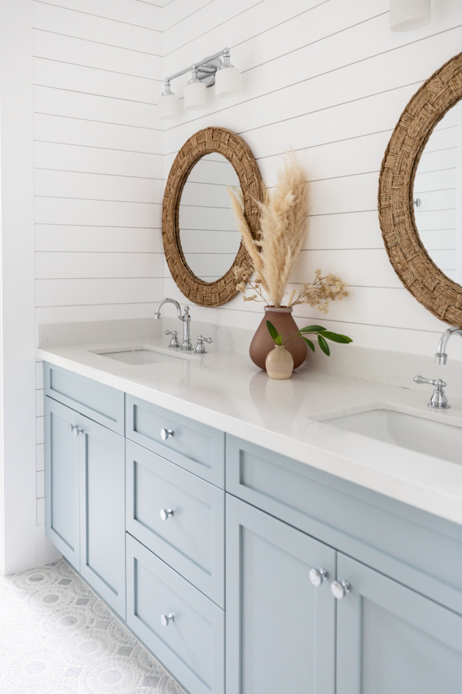Example of a mid-sized beach style mosaic tile floor, double-sink and shiplap wall bathroom design in Phoenix with blue cabinets