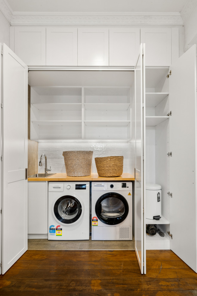Transitional laundry room in Sydney.