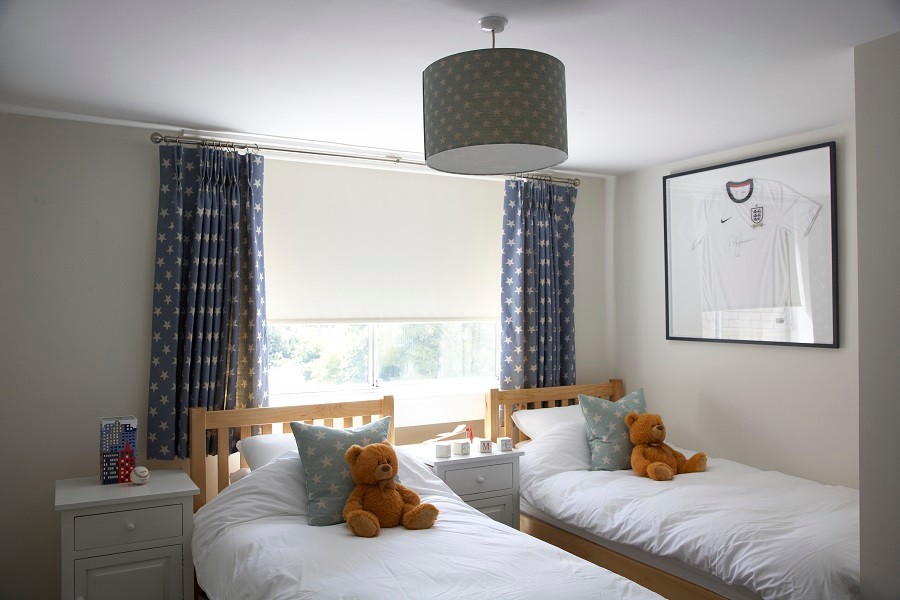 This is an example of a mid-sized transitional kids' bedroom for kids 4-10 years old and boys in London with carpet.