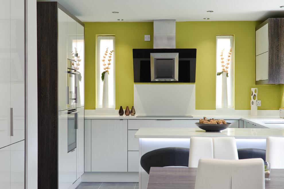 Inspiration for a large contemporary l-shaped kitchen in Kent with white cabinets and a peninsula.