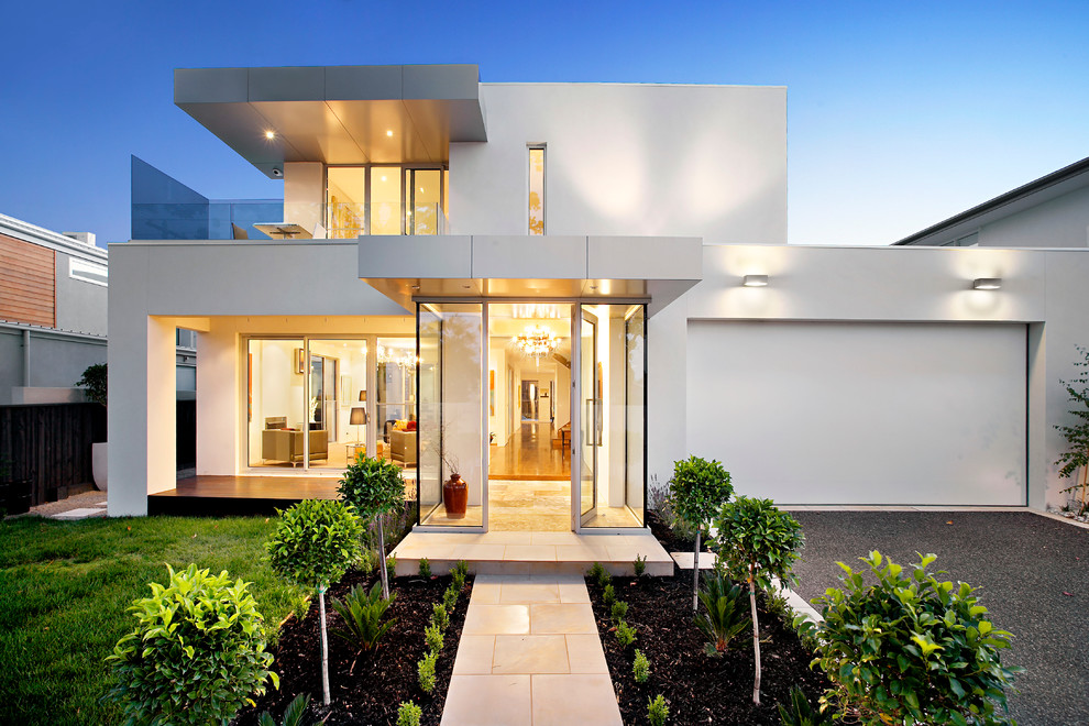 Inspiration for a contemporary two-storey white exterior in Melbourne with a flat roof.