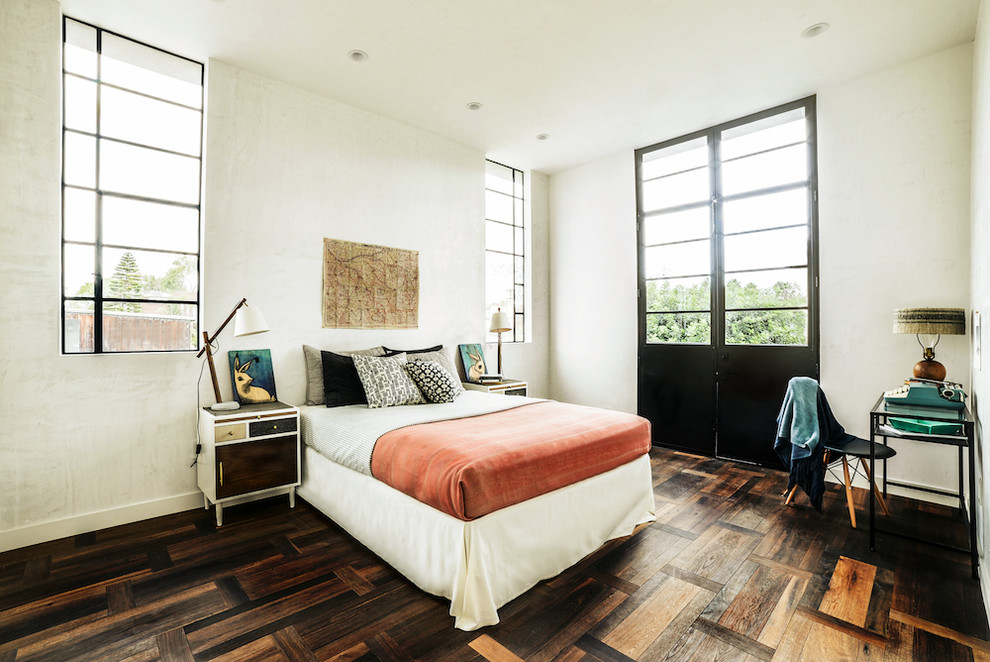 This is an example of a mid-sized guest bedroom in Los Angeles with white walls and dark hardwood floors.