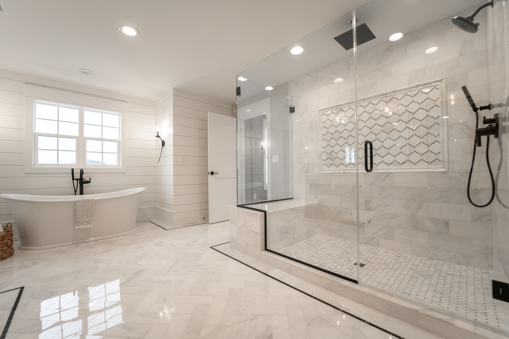 Transitional bathroom in Chicago with a freestanding tub, a corner shower, gray tile, white walls, white floor and a hinged shower door.