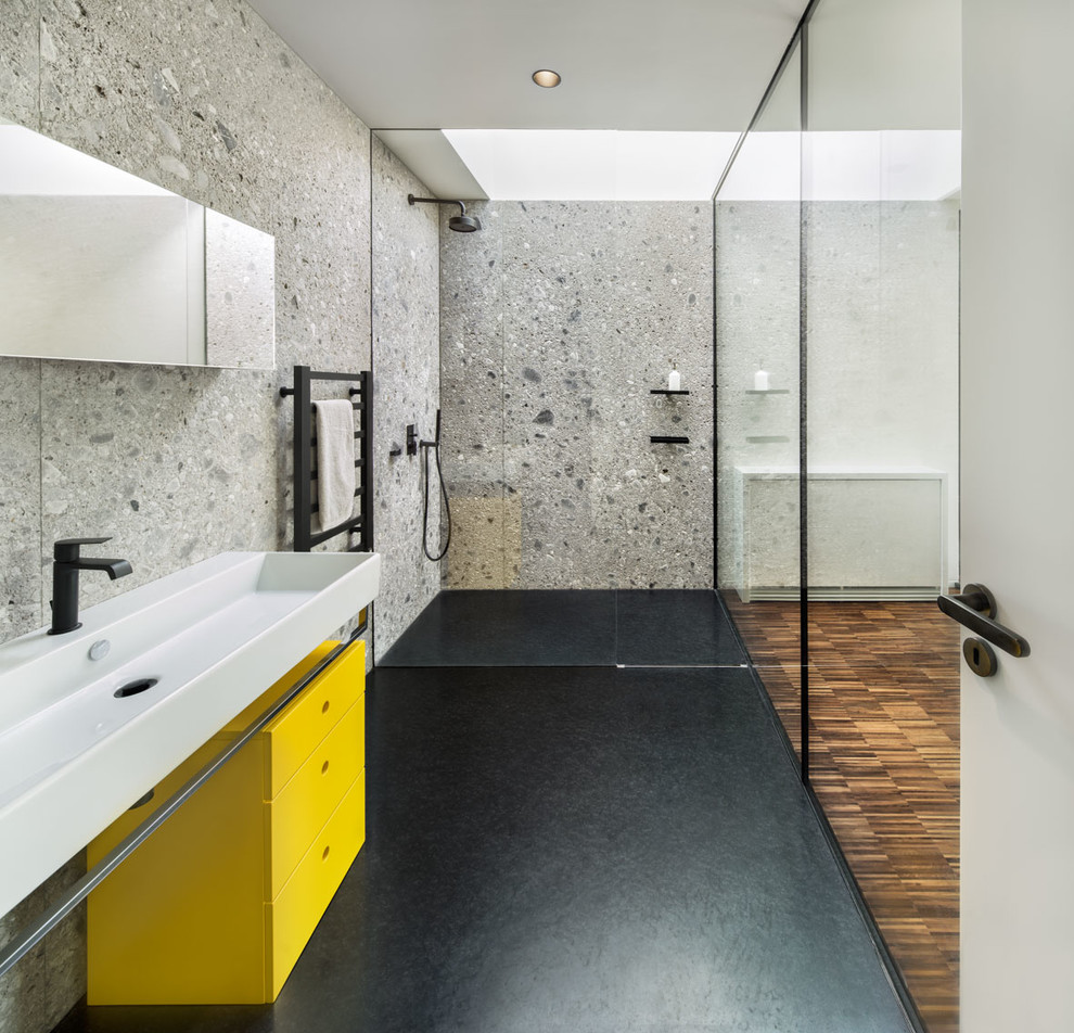 Design ideas for a contemporary bathroom in London with flat-panel cabinets, yellow cabinets, a curbless shower and a trough sink.