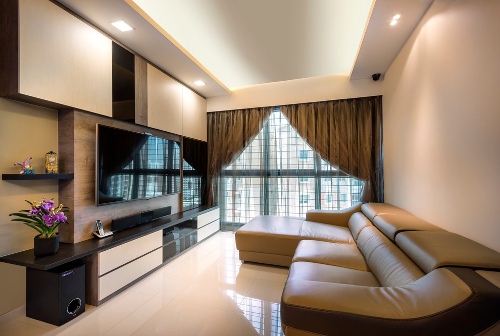Inspiration for a traditional enclosed living room in Singapore with beige walls, a wall-mounted tv and beige floor.