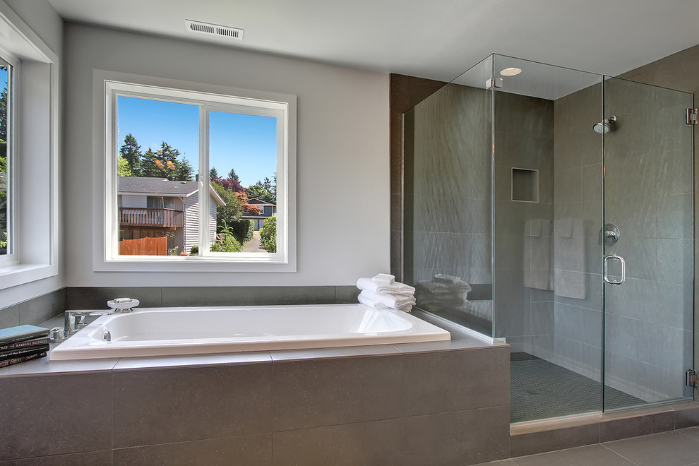 Photo of an expansive transitional master bathroom in Seattle with an undermount sink, shaker cabinets, dark wood cabinets, marble benchtops, a drop-in tub, an open shower, a two-piece toilet, gray tile, ceramic tile, grey walls and porcelain floors.