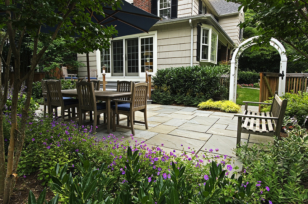 Inspiration for a small traditional backyard partial sun garden for spring in DC Metro with natural stone pavers.