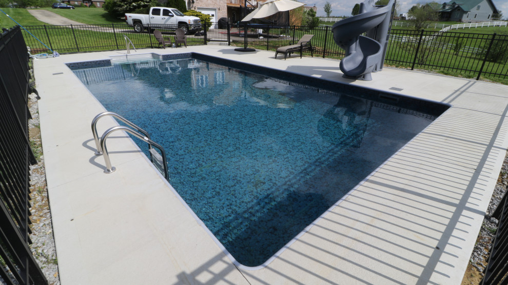 Design ideas for a large modern rectangular pool in Other with concrete slab.