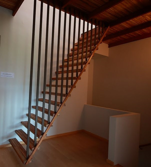 Inspiration for a small country wood floating staircase in Perth with wood railing.