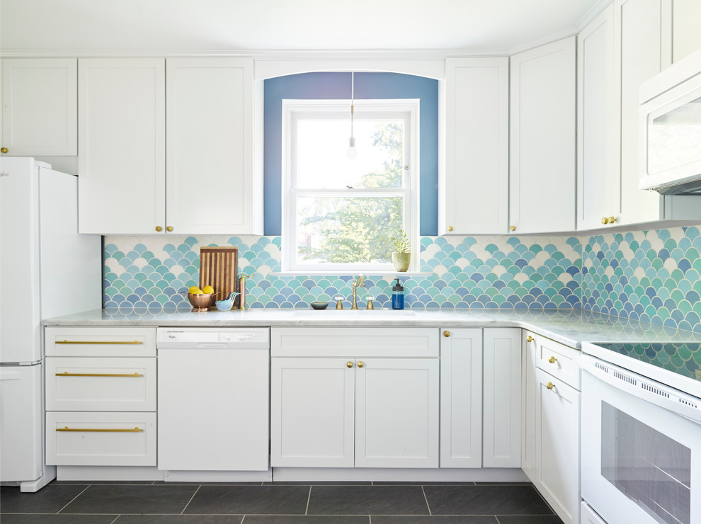 This is an example of a large eclectic separate kitchen in Philadelphia with a drop-in sink, shaker cabinets, white cabinets, marble benchtops, blue splashback, ceramic splashback, white appliances, slate floors and no island.