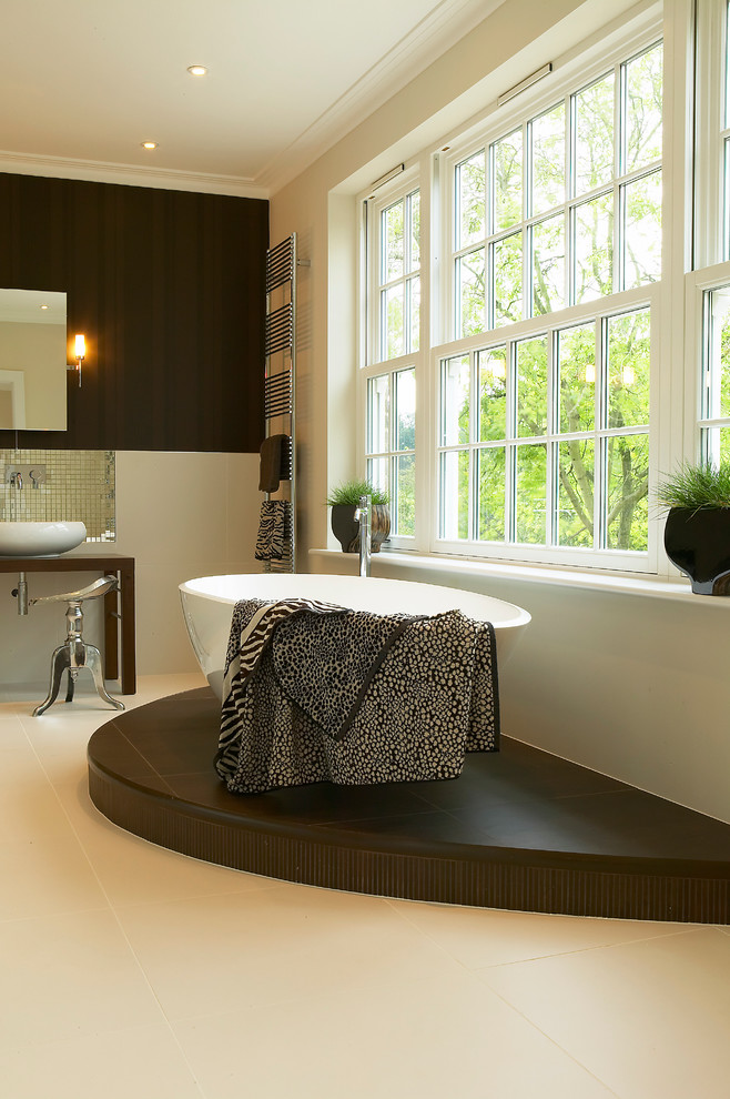 Design ideas for a mid-sized contemporary master bathroom in Berkshire with a vessel sink, wood benchtops, a freestanding tub, a corner shower, a one-piece toilet, beige tile, porcelain tile, brown walls and porcelain floors.