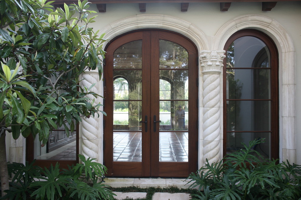 Design ideas for a mediterranean entryway in Jacksonville with a double front door and a glass front door.