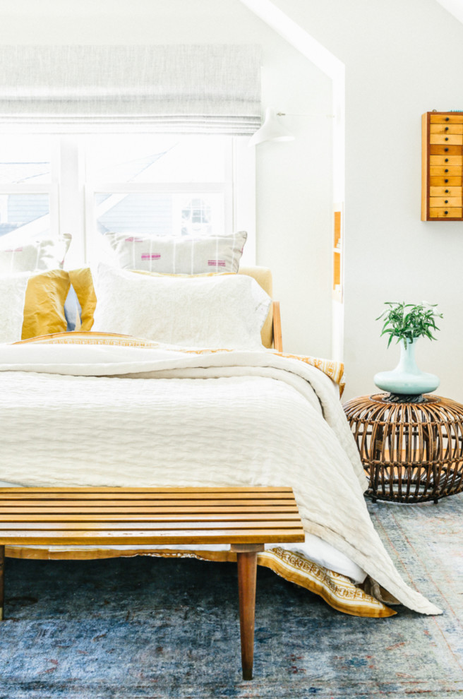 Eclectic master bedroom in Portland Maine with white walls.
