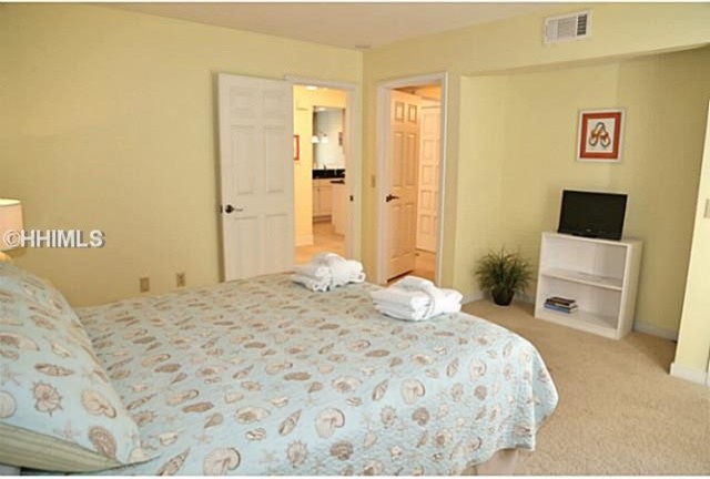 This is an example of a mid-sized beach style guest bedroom in Atlanta with blue walls, carpet, no fireplace and blue floor.