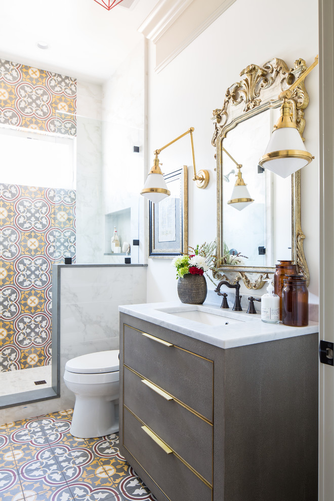 Inspiration for an eclectic 3/4 bathroom in San Diego with flat-panel cabinets, grey cabinets, an alcove shower, a two-piece toilet, multi-coloured tile, beige walls, an undermount sink, multi-coloured floor and grey benchtops.
