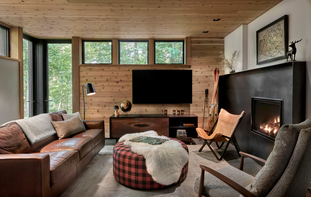 Lawless Retreat - Designed in sharp contrast to the glass walled living room above, this space sits partially underground. Precisely comfy for movie night.