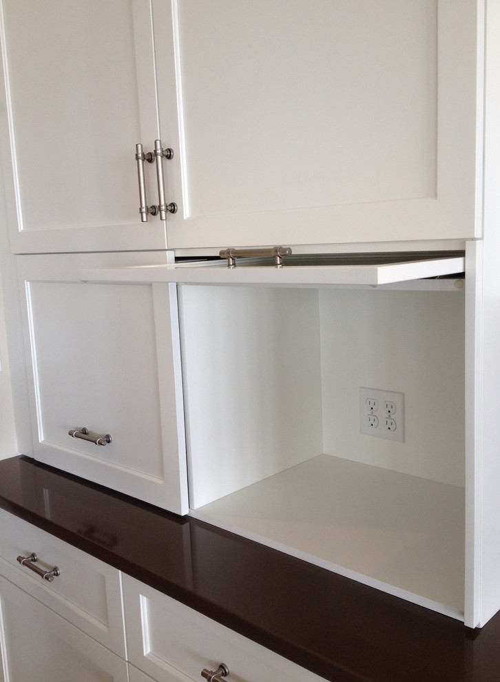 Eat-in kitchen - transitional ceramic tile eat-in kitchen idea in Boston with a double-bowl sink, recessed-panel cabinets, white cabinets, quartz countertops, brown backsplash, glass tile backsplash, stainless steel appliances and an island