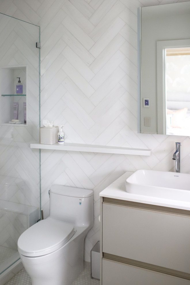 This is an example of a mid-sized beach style master wet room bathroom in New York with flat-panel cabinets, a one-piece toilet, white tile, a vessel sink, engineered quartz benchtops, white benchtops, a single vanity, a built-in vanity, mosaic tile and porcelain floors.