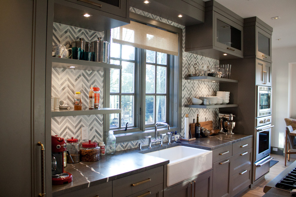 Inspiration for a mid-sized single-wall eat-in kitchen in Vancouver with a farmhouse sink, recessed-panel cabinets, grey cabinets, quartzite benchtops, stainless steel appliances, medium hardwood floors and with island.