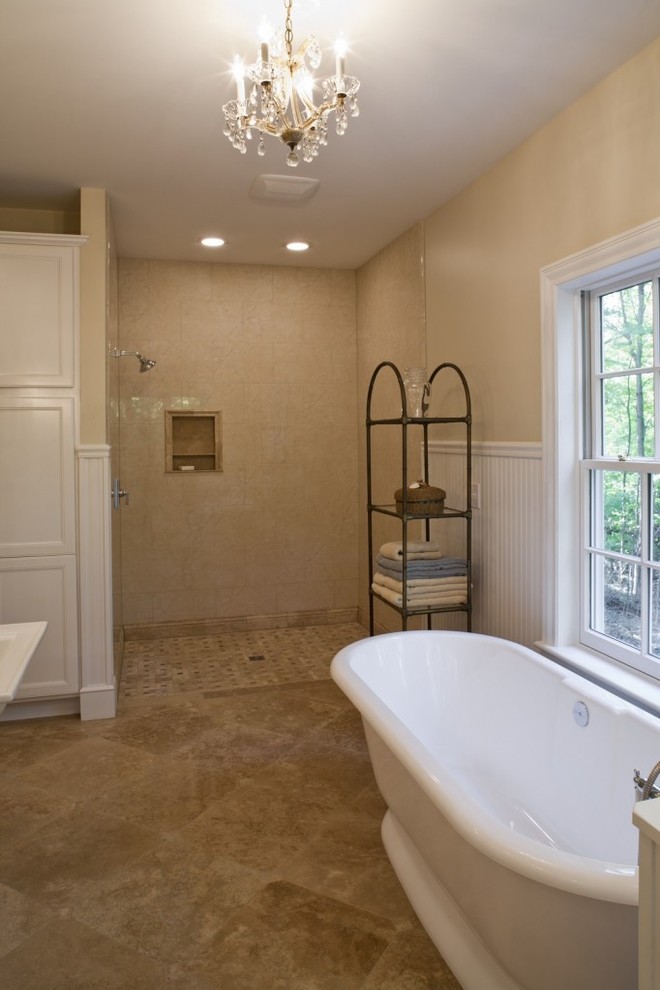 Transitional master bathroom in Columbus with beaded inset cabinets, white cabinets, a freestanding tub, a curbless shower, a two-piece toilet, beige walls and limestone floors.