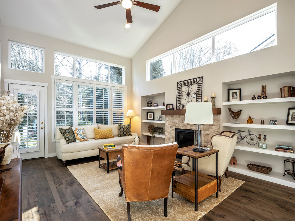 Mid-sized transitional open concept living room in Seattle with beige walls, medium hardwood floors, a standard fireplace, a stone fireplace surround, no tv and brown floor.