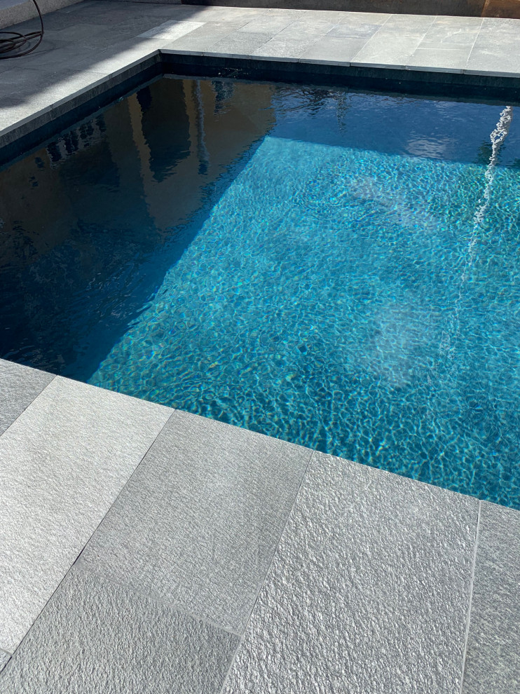 This is an example of a scandinavian backyard pool in Stockholm with natural stone pavers.