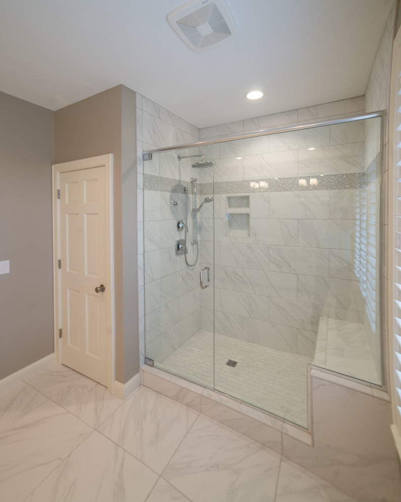 Inspiration for a large transitional master marble floor alcove shower remodel with shaker cabinets, white cabinets, beige walls, an undermount sink and quartz countertops
